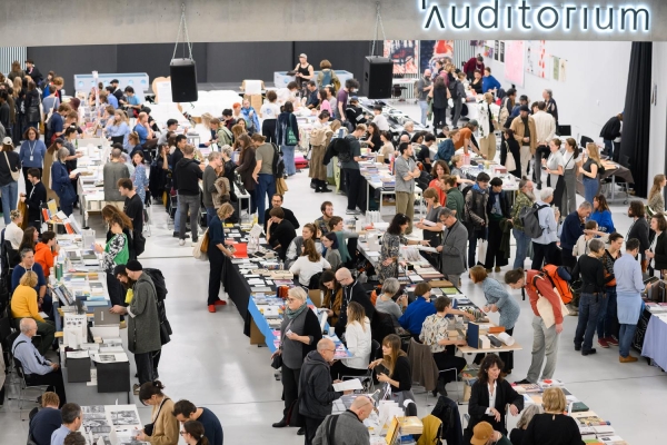 Atrium
                                          der Universität für Angewandte Kunst Wien während der Art Book Fair, gefüllt mit Menschen und Messeständen