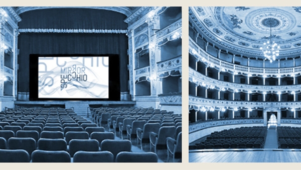 Blue photograph
                                          of an opera house with a stage and rows of seats