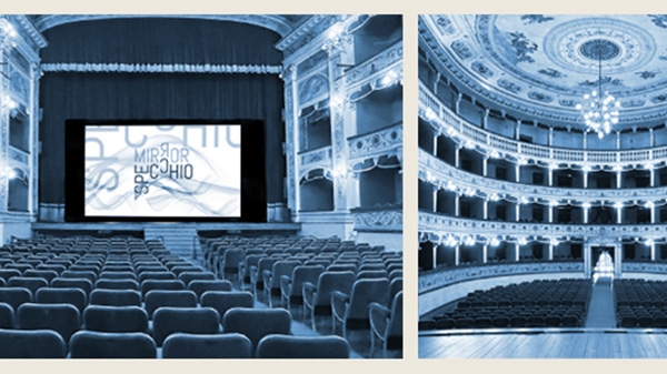 Blue photograph of an opera house with a stage and rows of seats