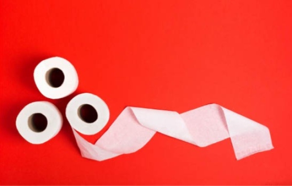 three rolls of toiletpaper on a red background