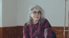 Die Künstlerin Leonor Antunes sitzend in ihrer Ausstellung